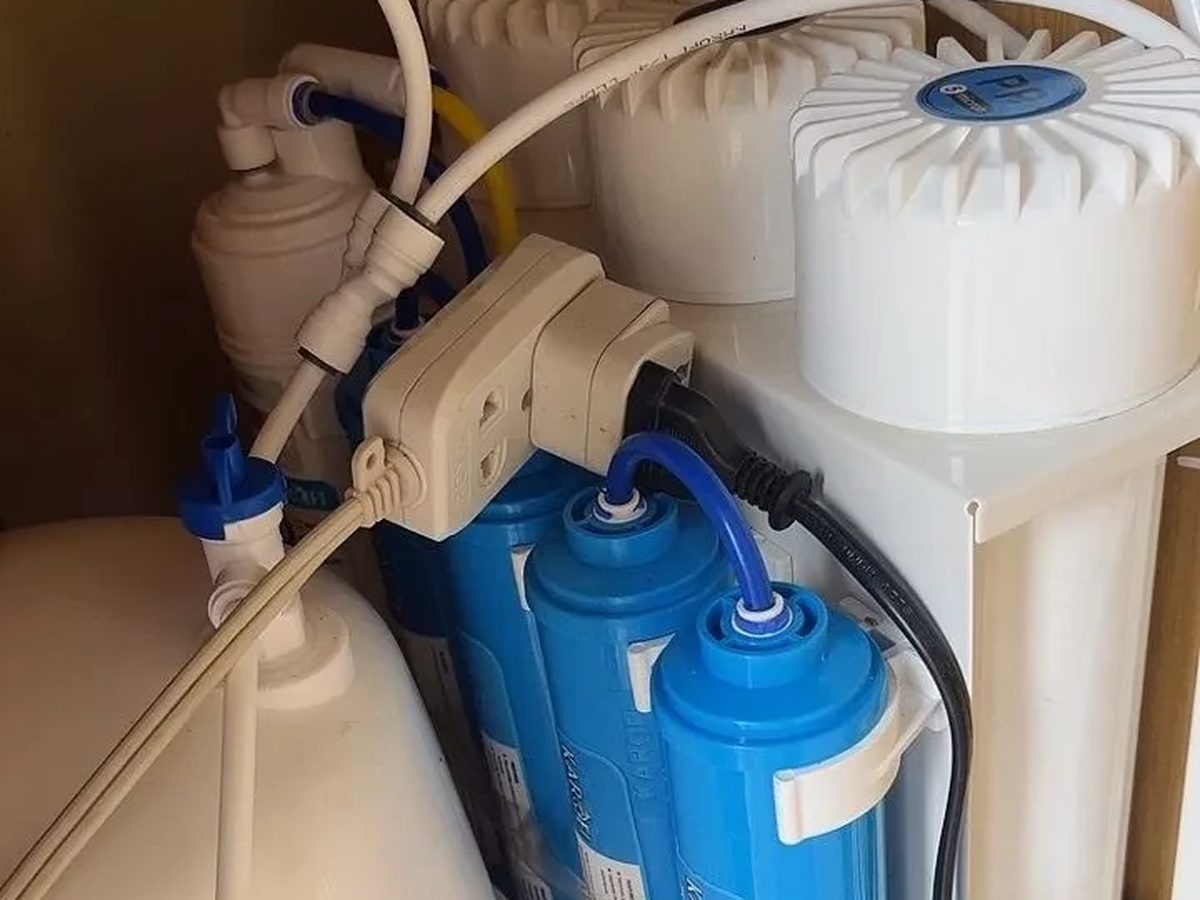 Karofi RO water purifier with storage tank in a wooden cabinet